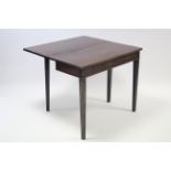 A 19th century mahogany tea table with moulded edge to the rectangular fold-over top, & on moulded