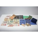 Various coin sets; British & foreign banknotes; & two sealed £1 packs of un-circulated 2p coins.