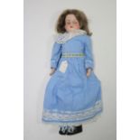 An Armand Marseille bisque head girl doll (370 AM 2/0X DEP) with blue sleeping eyes, open mouth, and