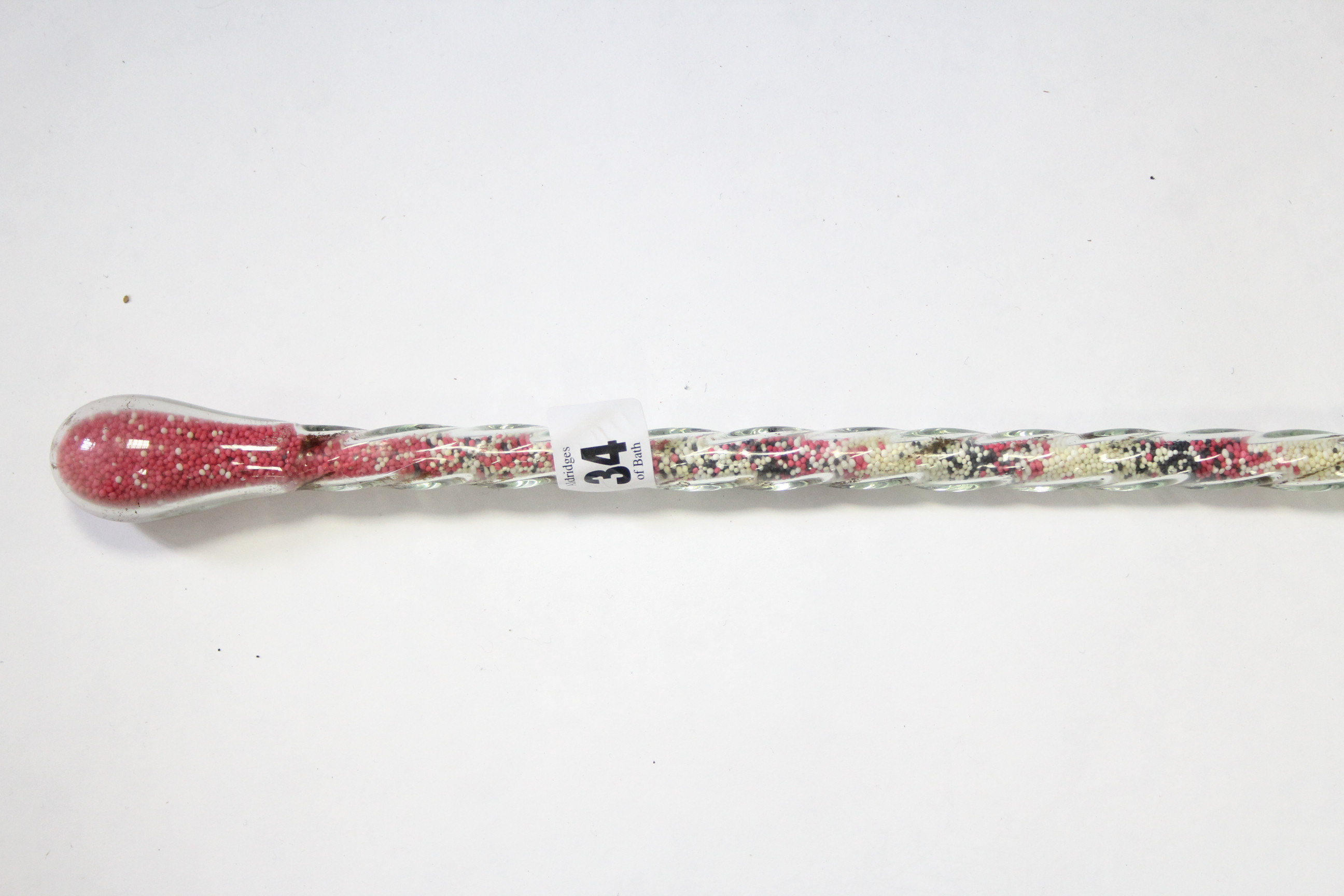 A Victorian glass candy cane, 41” long.