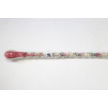 A Victorian glass candy cane, 41” long.