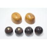 A pair of treen milliner’s blocks, 7¾” x 6¼”; & a set of four lawn bowls.