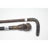 A late 19th/early 20th century ebony gent’s walking cane with yellow-metal collar, & with carved