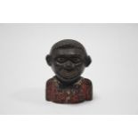 A late 19th/early 20th century money bank “The Young Nigger”, 4¼" high.