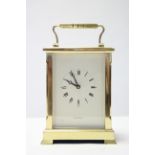 A large brass carriage clock, the white dial with black roman numerals & signed “Shortland Bowen”,