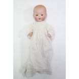 An Armand Marseille bisque head baby doll (A M Germany 351/3½k) with open eyes & mouth, and with