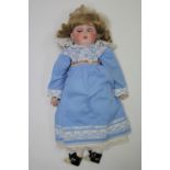 A Simon & Halbig bisque head girl doll (K R) with blue sleeping eyes, open mouth, and with