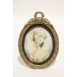 A late 19th century French portrait miniature of a young lady wearing green dress & bonnet,