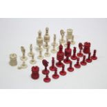 A carved bone chess set of natural & red-stained colour (size of Kings: 4" high), slight faults.