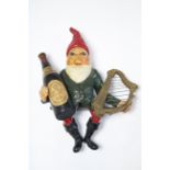 A 1950’s painted composition Guinness advertising gnome figure holding a bottle of Guinness in his