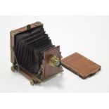 53. A late 19th/early 20th century mahogany plate camera with brass fittings, 8” wide.