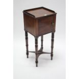 A Victorian mahogany pot cupboard enclosed by panel door, & on ring-turned tapered legs, 13½" wide.