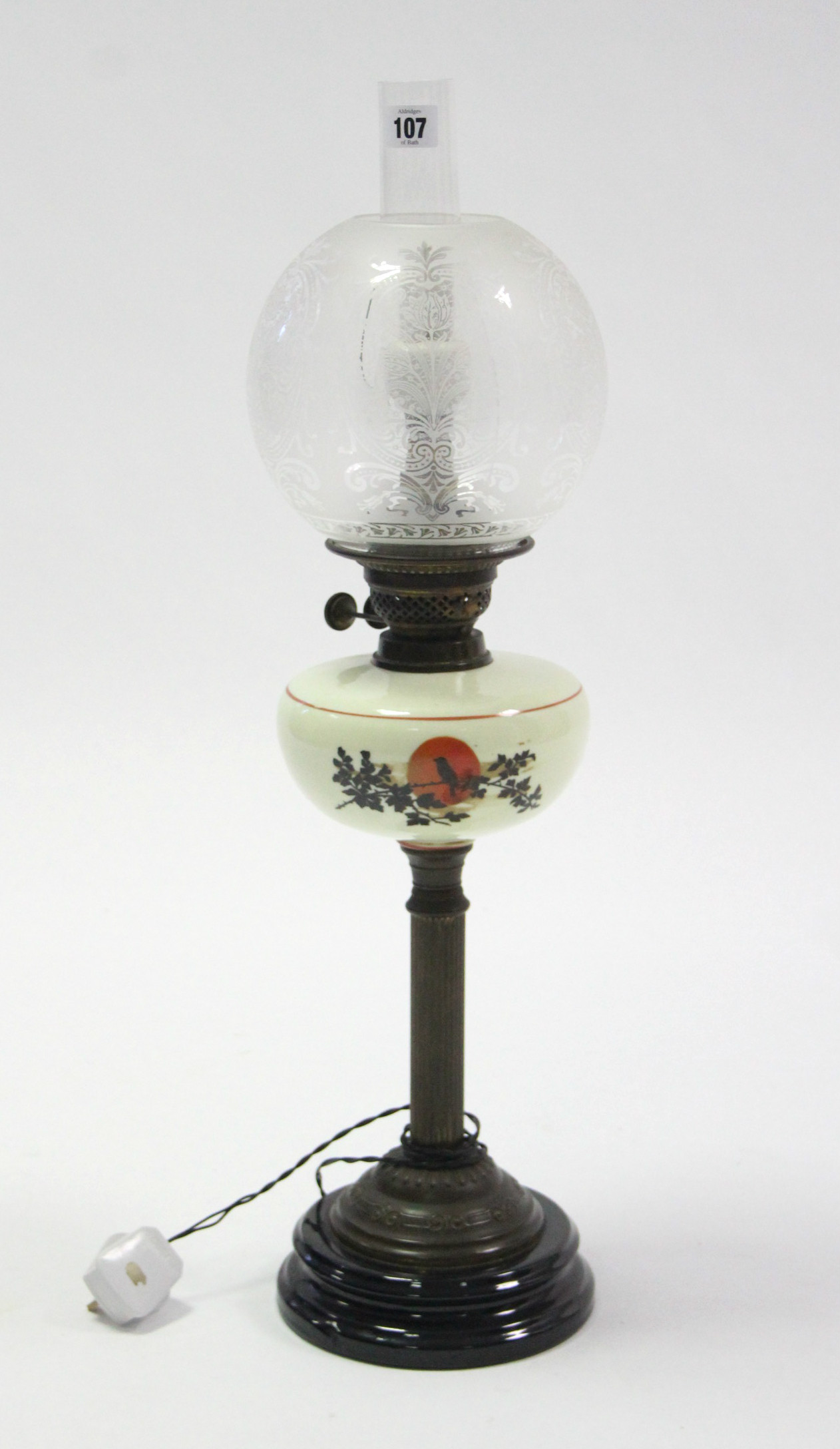 A Victorian brass oil table lamp (converted to electricity) with fluted centre column, glass