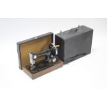 A Singer hand sewing machine with fibre-covered case.