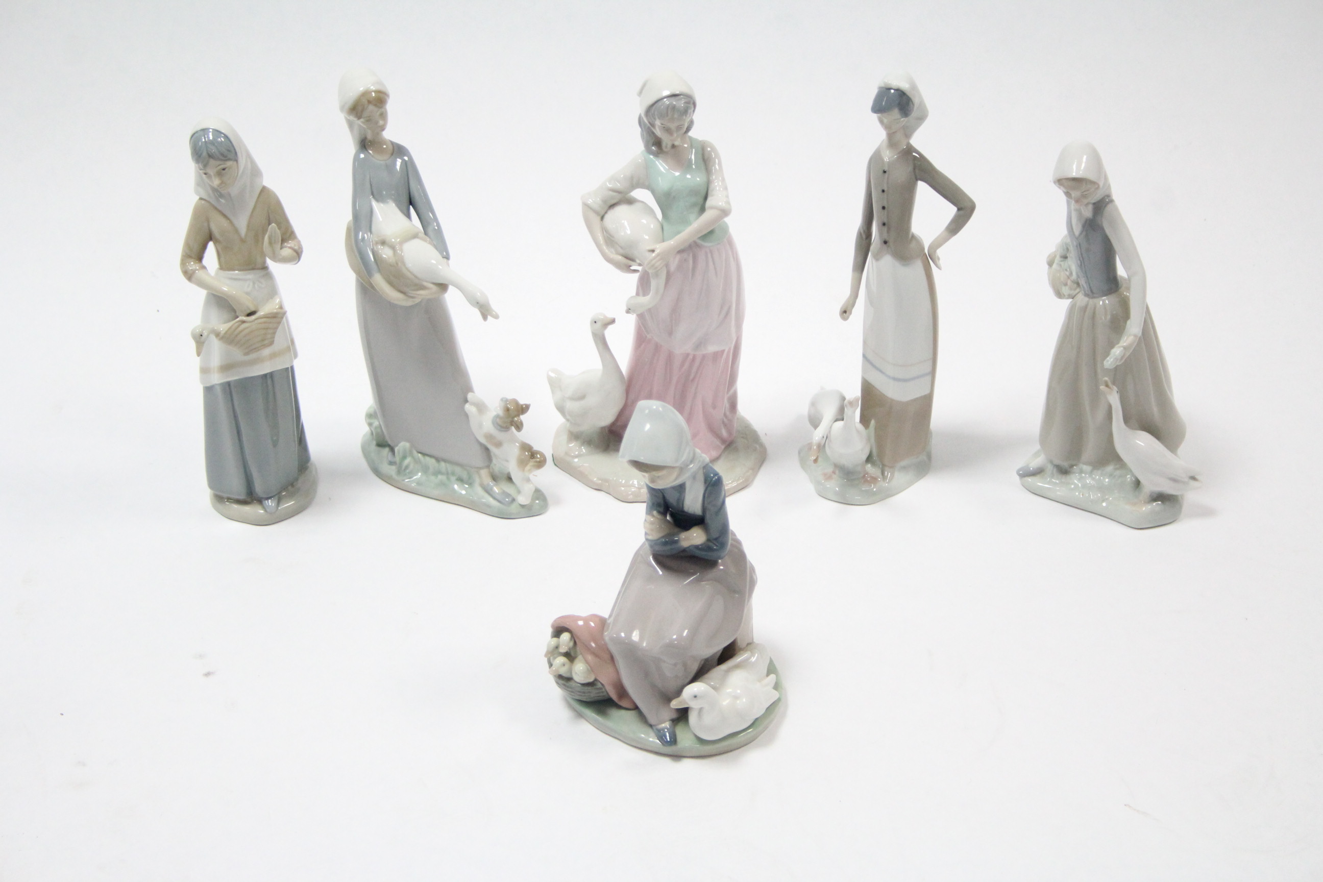 Six various Lladro & Lladro-style female figures, each with goose by her side