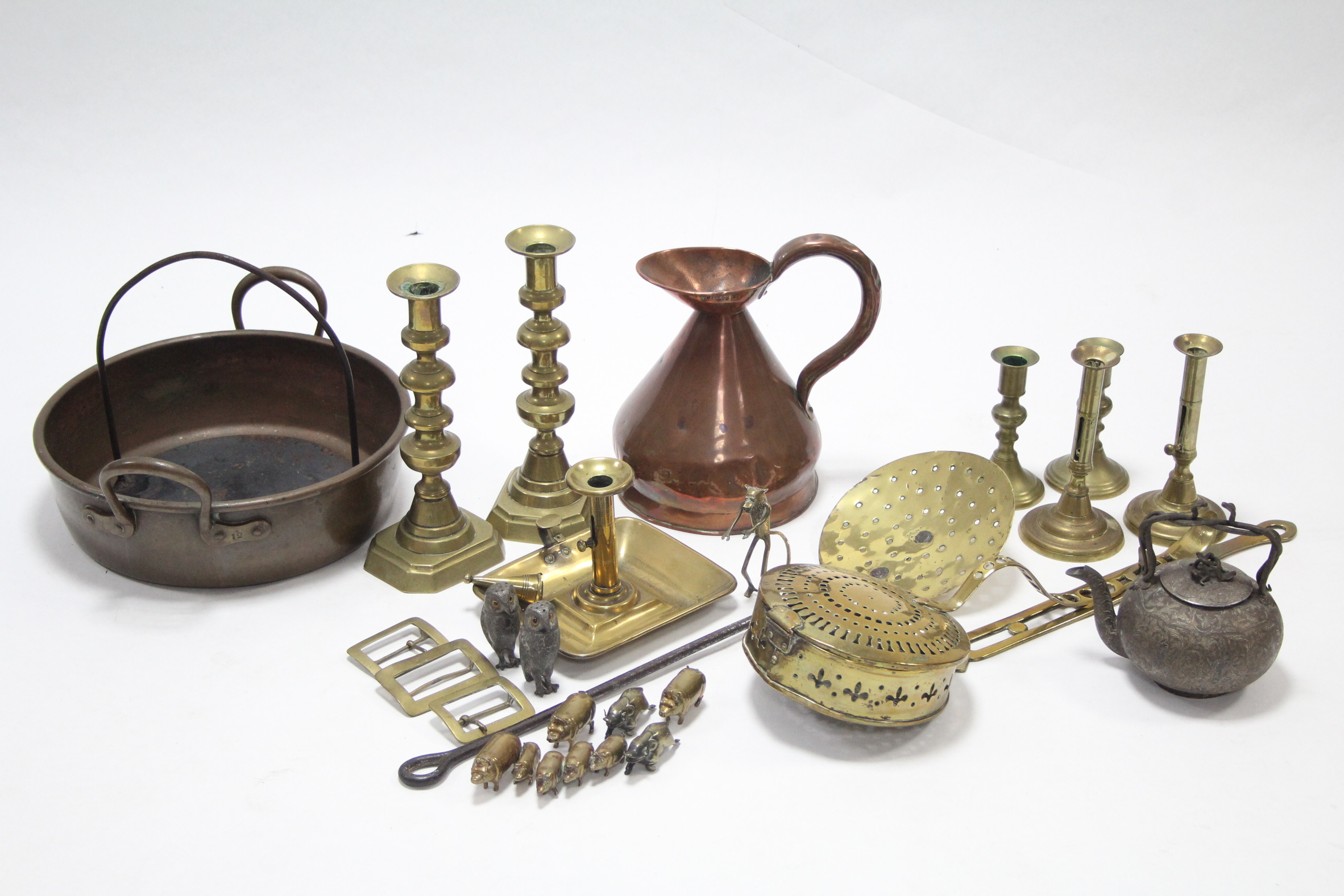 Three pairs of brass candlesticks; a copper ewer; a brass chestnut roaster; & various other items of