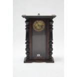 A late 19th/early 20th century wall clock with striking movement & in walnut case, 22" high;