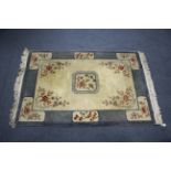 A modern Chinese wool rug of cream & mauve ground & with floral & bird panel design, 78” x 53”.