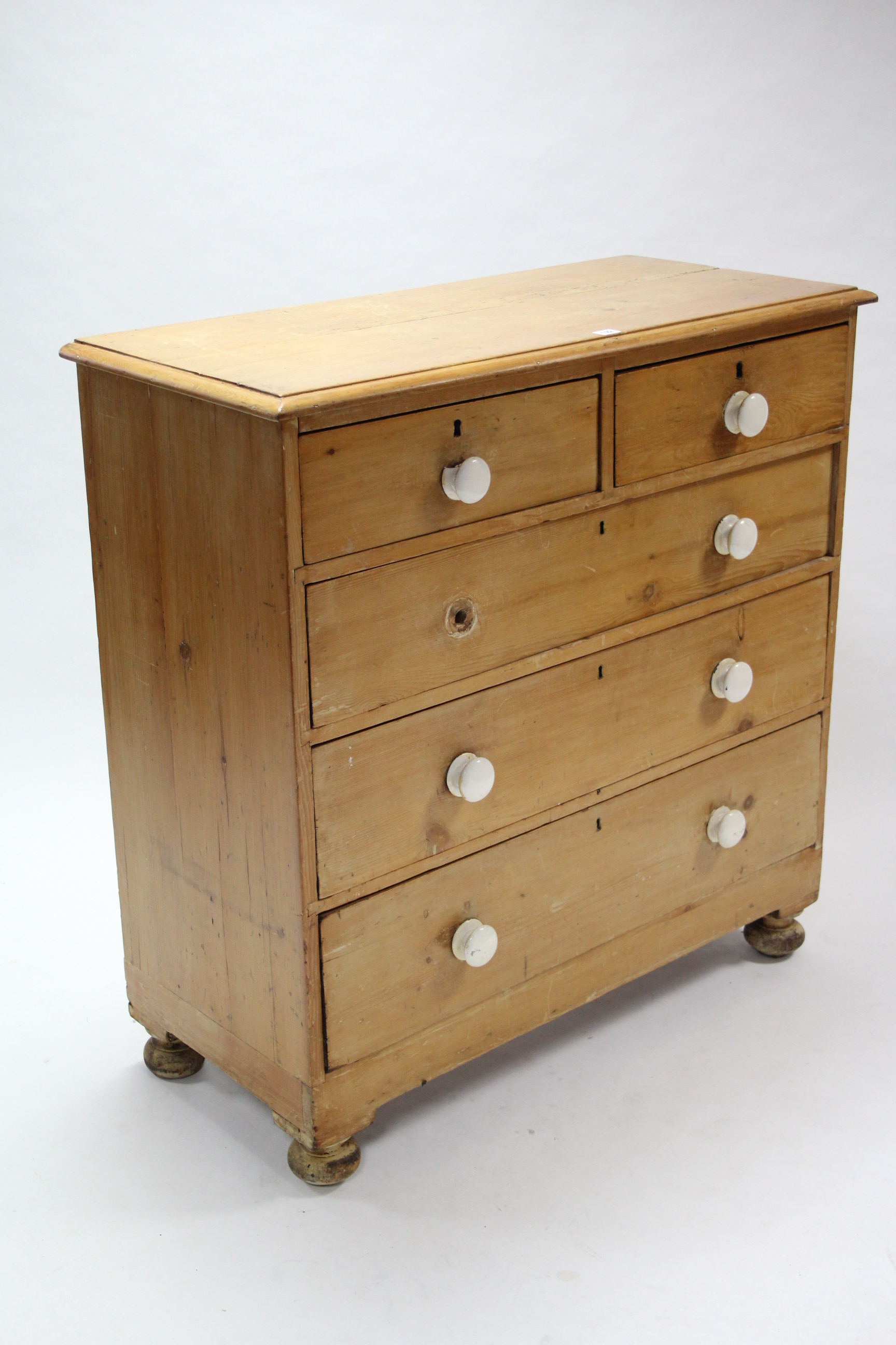 A Victorian pine chest fitted two short & three long graduated drawers with turned knob handles, &