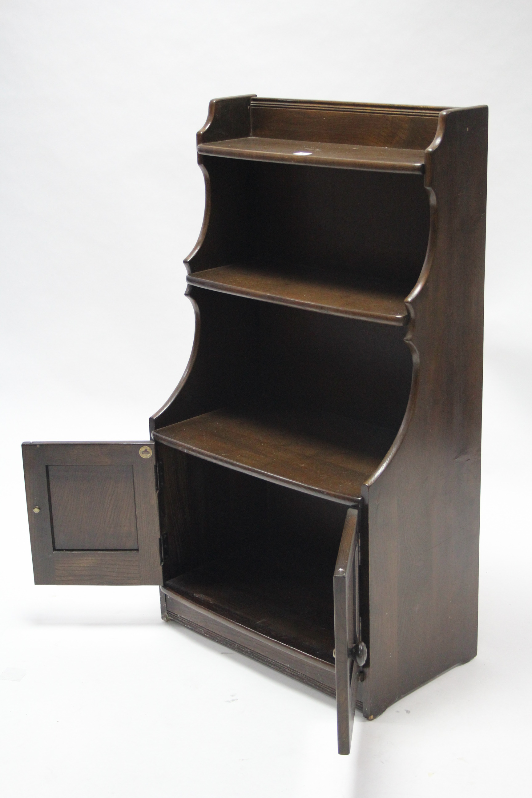 An Ercol dark elm small standing cabinet fitted two open shelves above cupboard enclosed by pair - Image 2 of 3