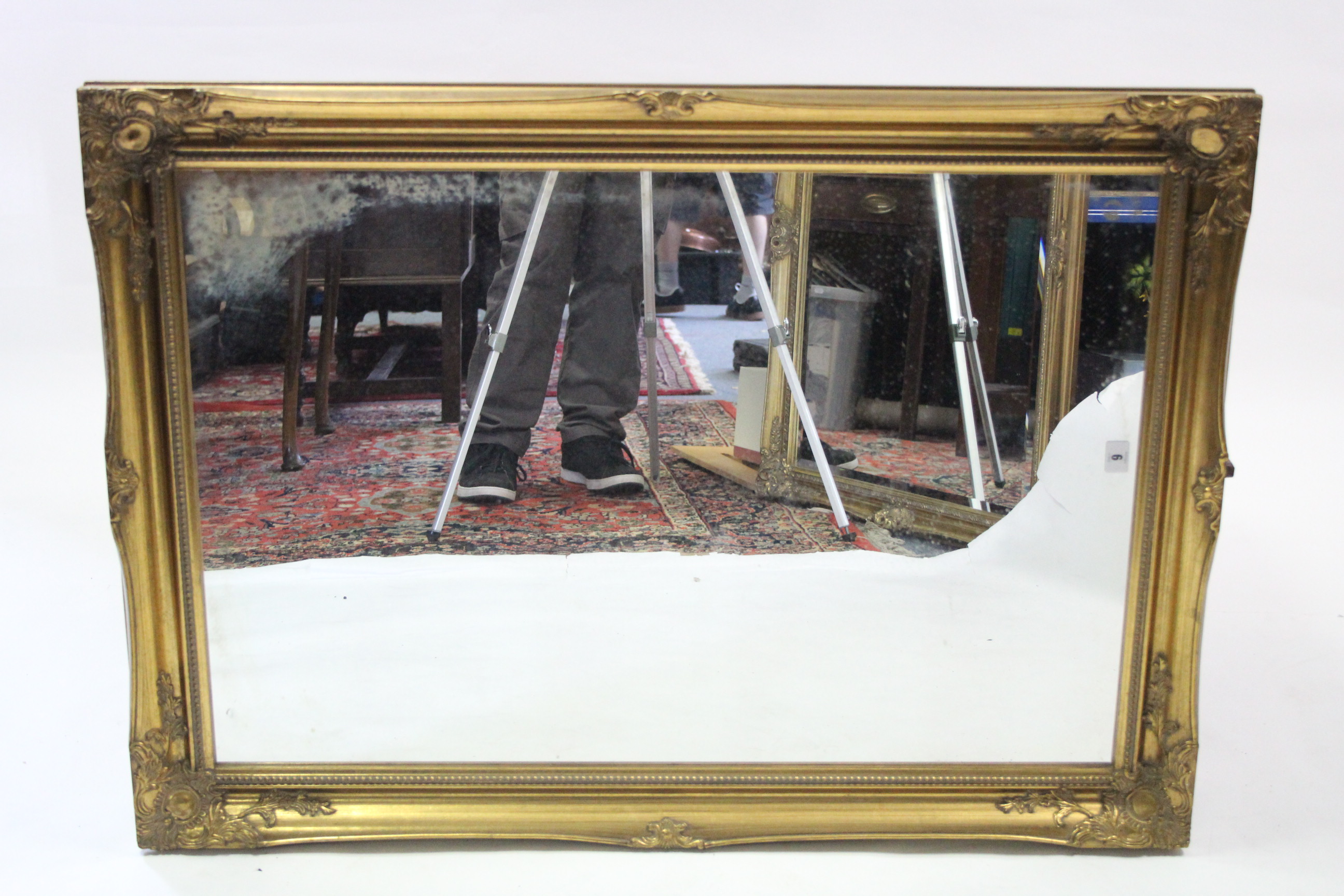 A large gilt frame rectangular wall mirror with raised scroll border & with beaded edge, 29½” x