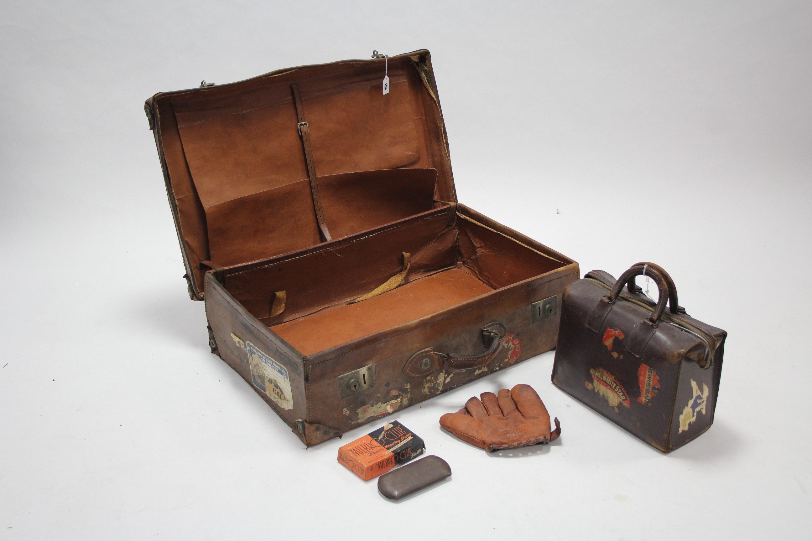 A large brown leather suitcase with twin locks; a leather briefcase/hold-all; a leather F35