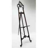 A Victorian-style carved mahogany easel, 78" high.