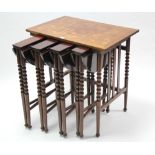 A mahogany nest of five occasional tables (four under one), the smaller tables with circular drop
