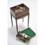 A 19th century mahogany trinket box containing various items of costume jewellery, & on later stand,