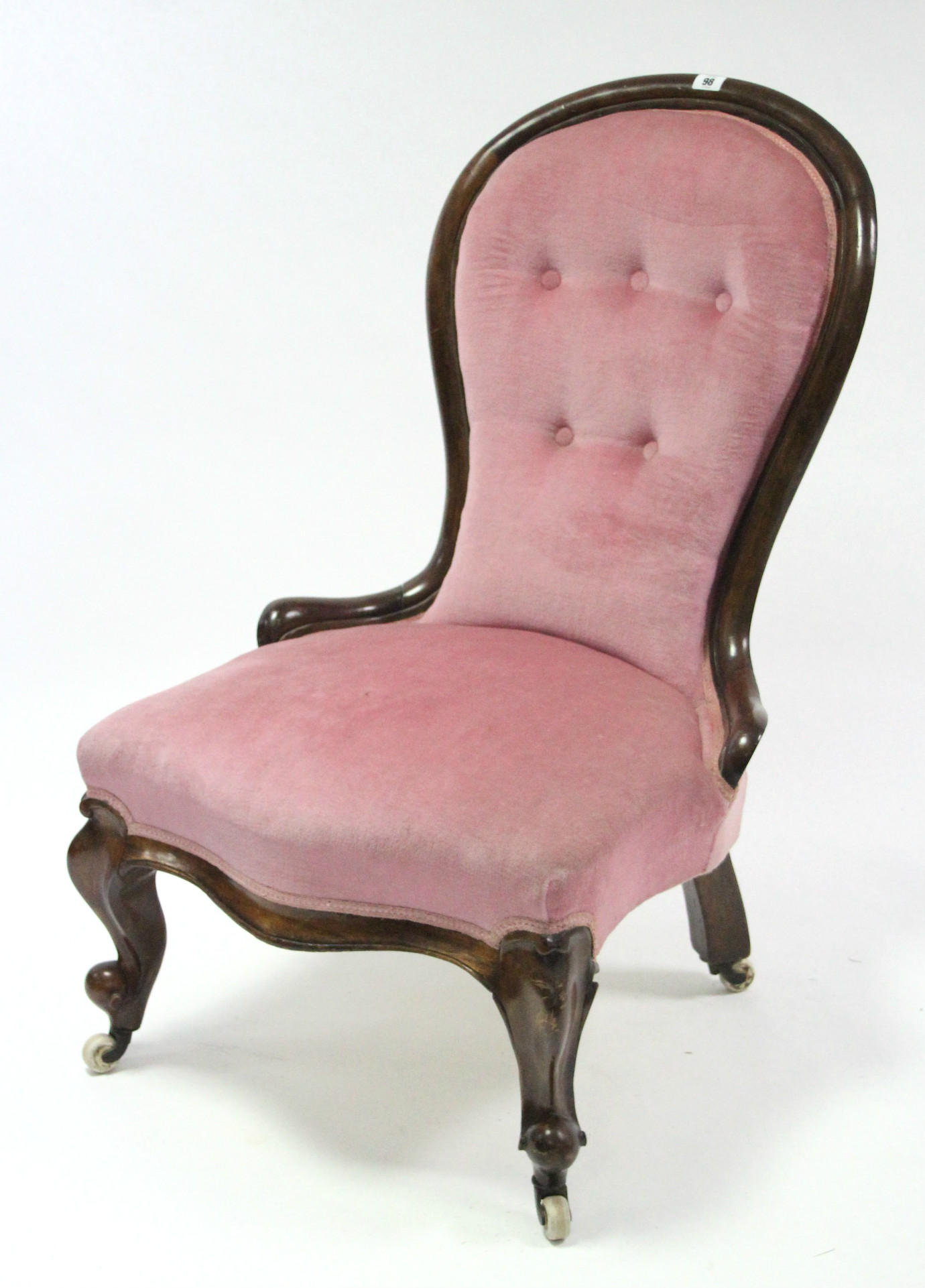 A Victorian beech-frame spoon-back nursing chair with buttoned back & sprung seat upholstered pink