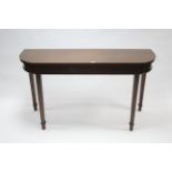 A mahogany side table with rounded ends & on square tapered legs, 55" wide.