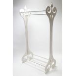 A white painted wooden clothes rail with pierced & shaped end supports, 37¾" long x 71¾" high.