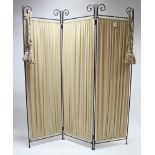 A wrought-metal three-fold draught screen with scroll terminals, & inset cream material 70" high.