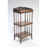 A mid-19th century rosewood three tier rectangular whatnot with carved pierced tray-top, barley-