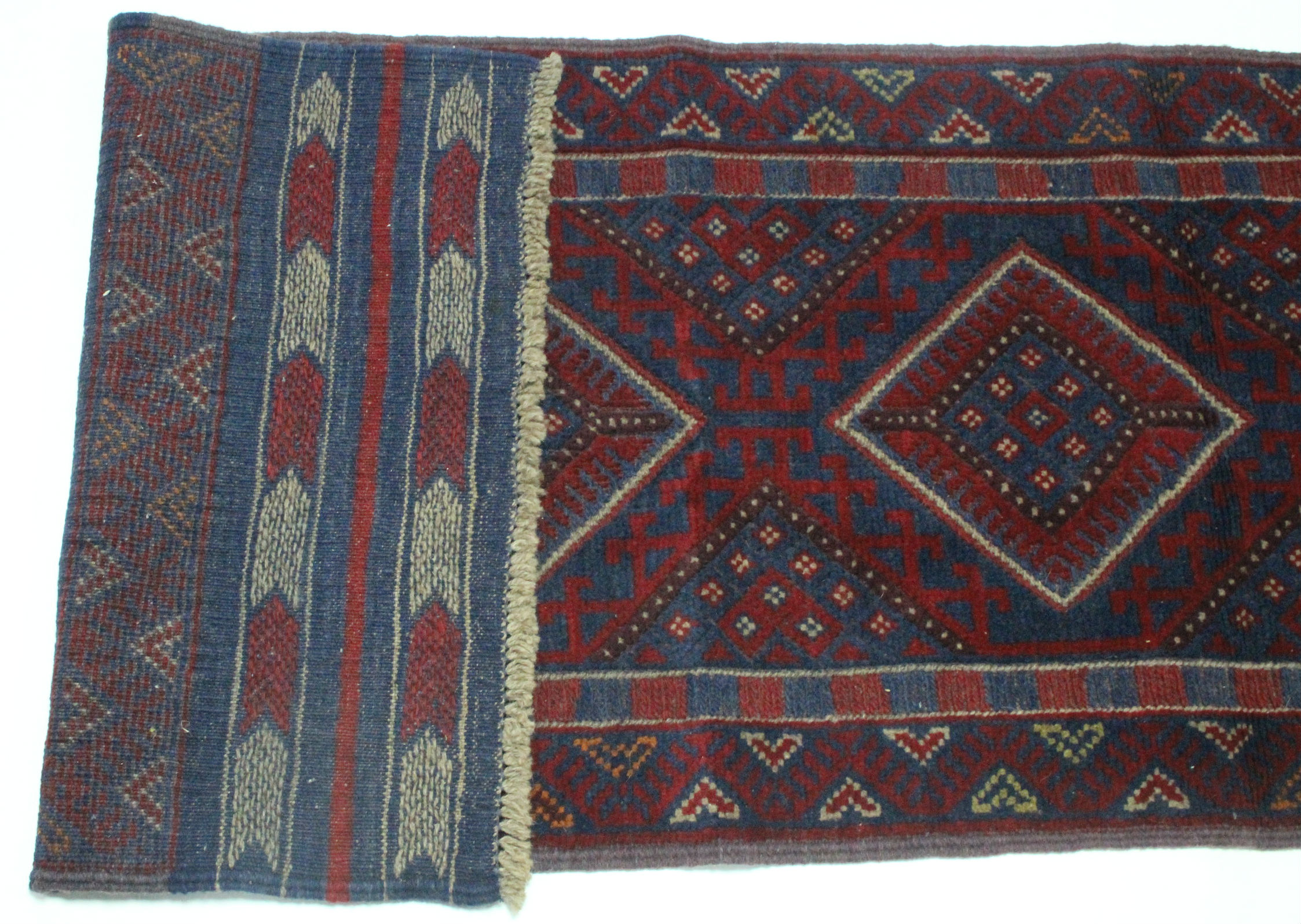 A Meshwari runner of crimson ground, with row of four lozenges to the centre in blue & ivory, wide - Image 2 of 3