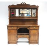 An Edwardian Aesthetic-style oak sideboard, the mirrored stage-back with broken-arch carved surmount