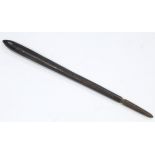 An ethnic carved wooden club of round narrow form; 28" long.