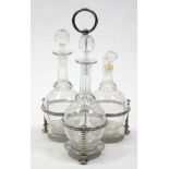 A late Victorian three-division decanter frame with centre ring handle, fitted three cut-glass