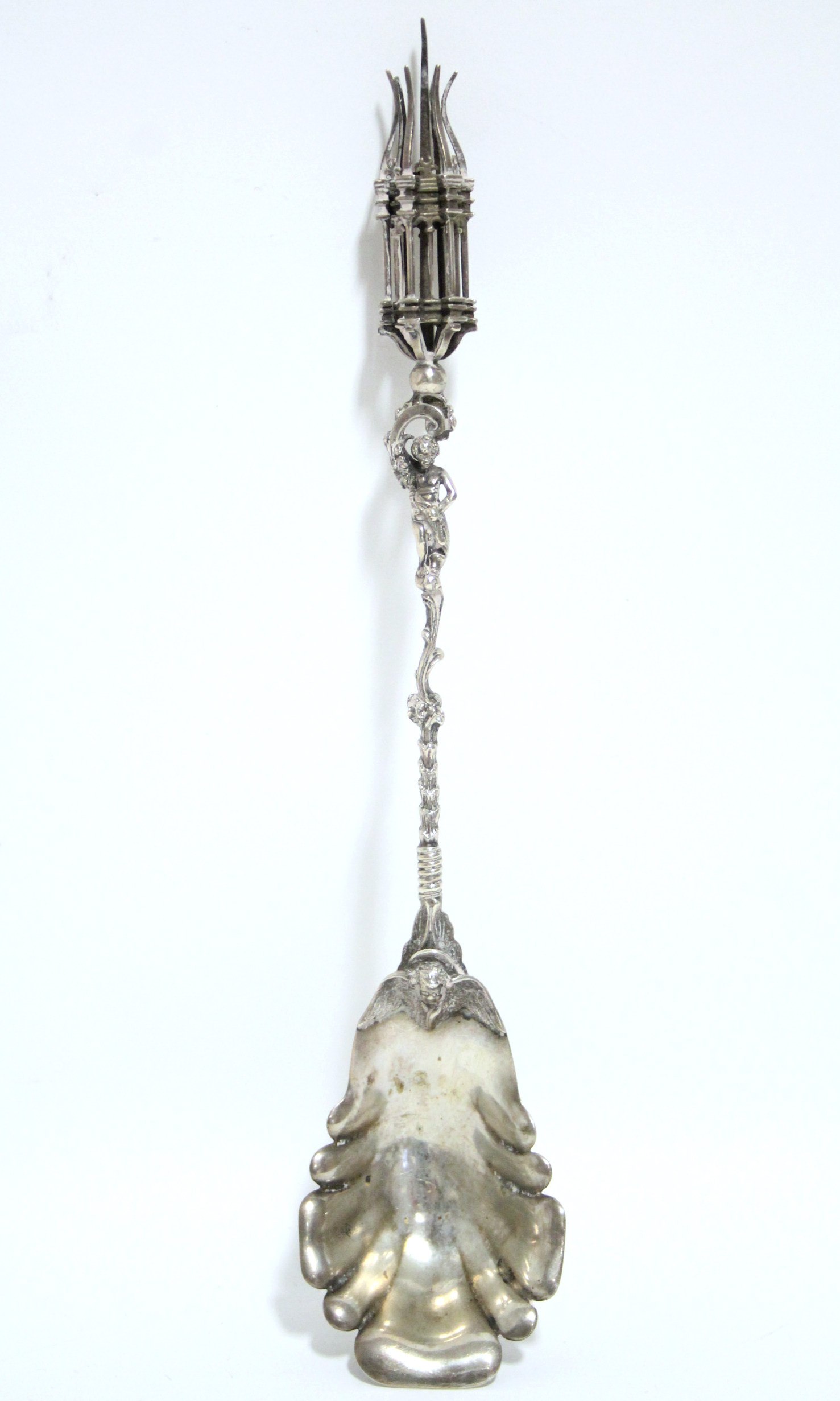 A continental service spoon with lobed oval bowl, a putto figure to the long rococo stem, a