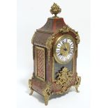 A French striking mantel clock in the 18th century style, in Boulle-inlaid rococo style case; 14¼"