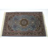 A Kashmir rug of pale blue ground, with centre medallion & all-over multicoloured floral design
