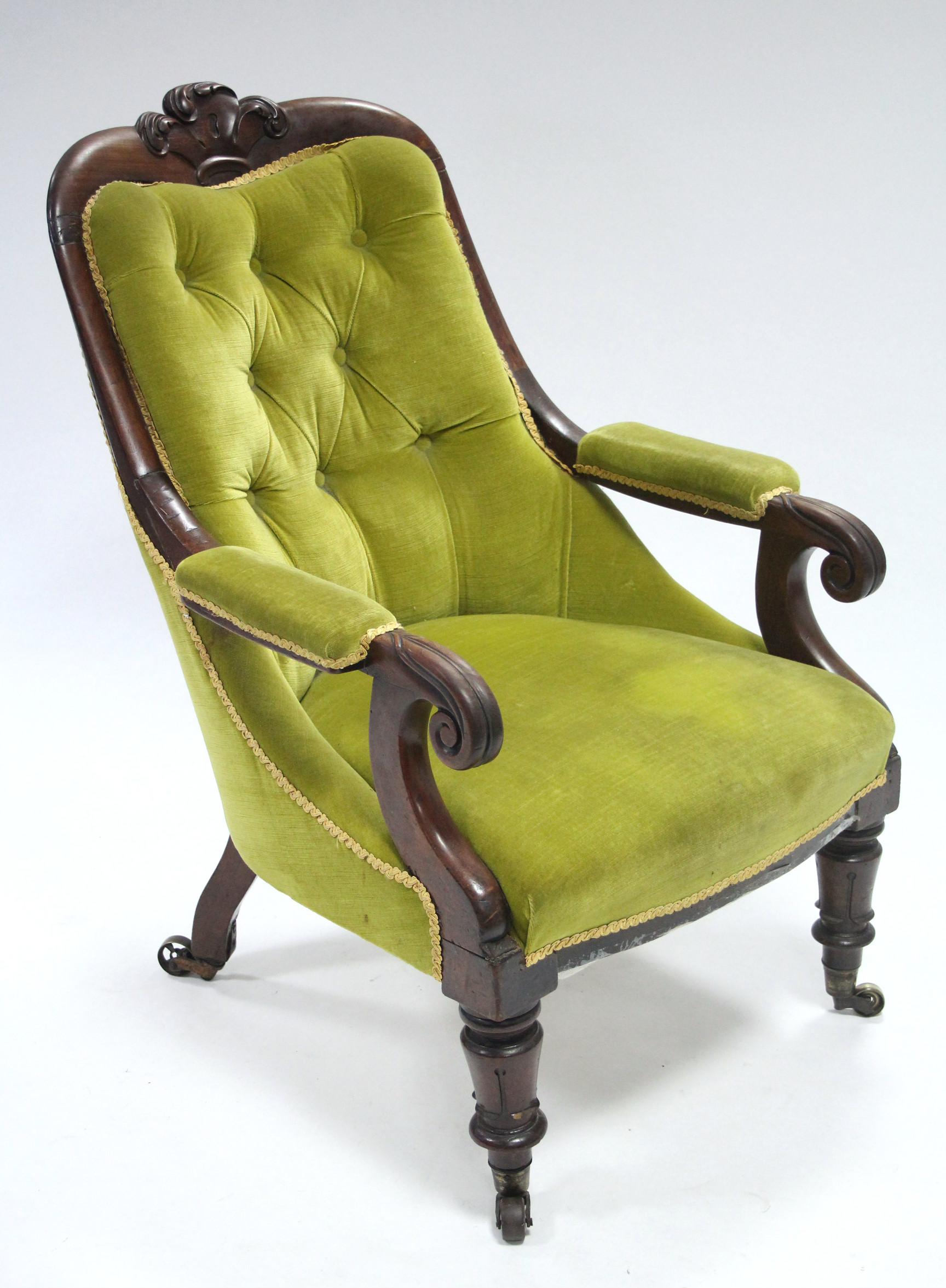 An early Victorian mahogany frame armchair with scroll arms & Prince-of-Wales feathers, the padded