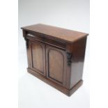 A Victorian mahogany chiffonier fitted two frieze drawers above a pair of panel doors, with scroll