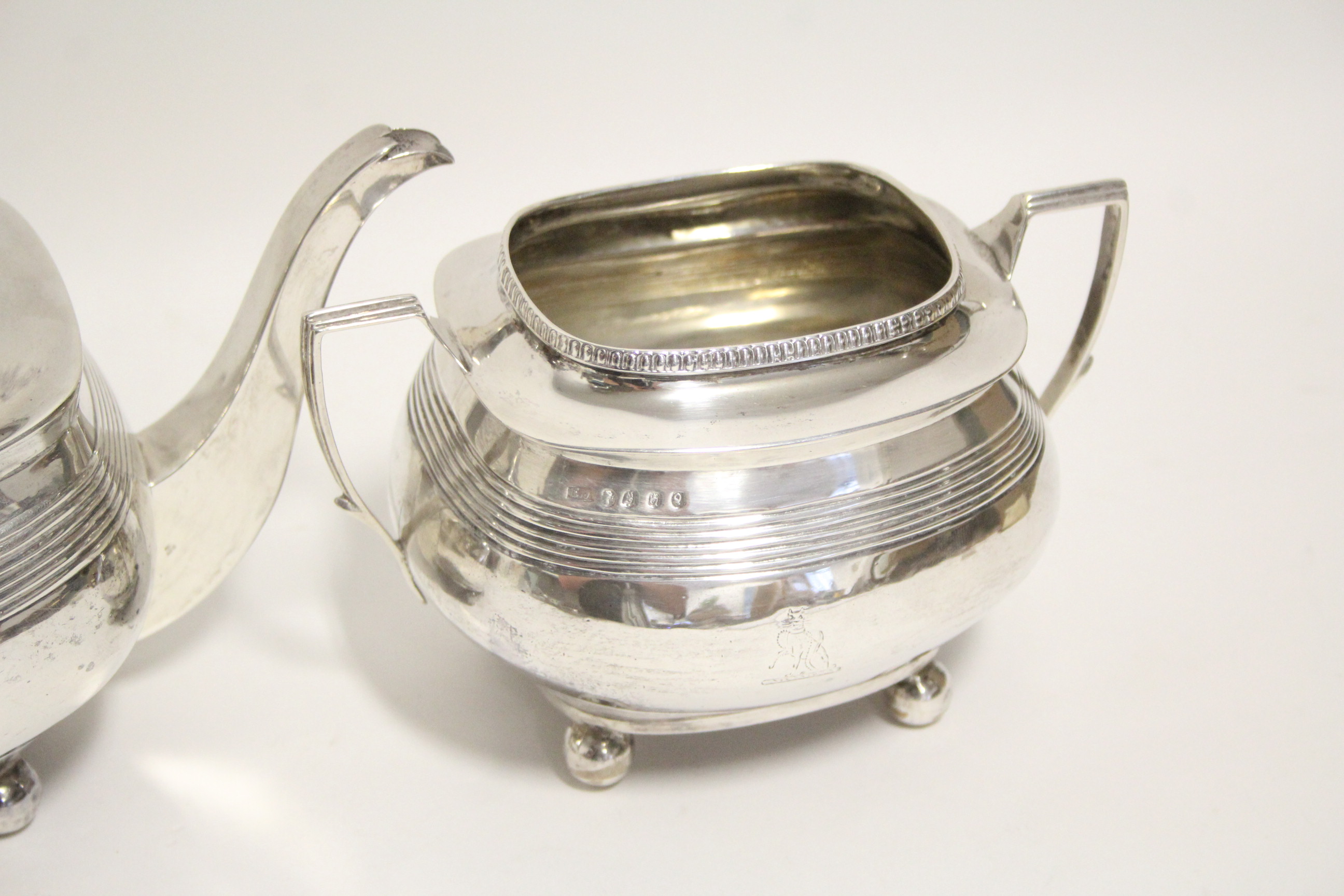 A George II teapot of compressed oblong form with reeded bands, on four ball feet, London 1810, by - Image 2 of 4