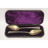 A pair of George III Old English table spoons with later engraved floral decoration & parcel-gilt