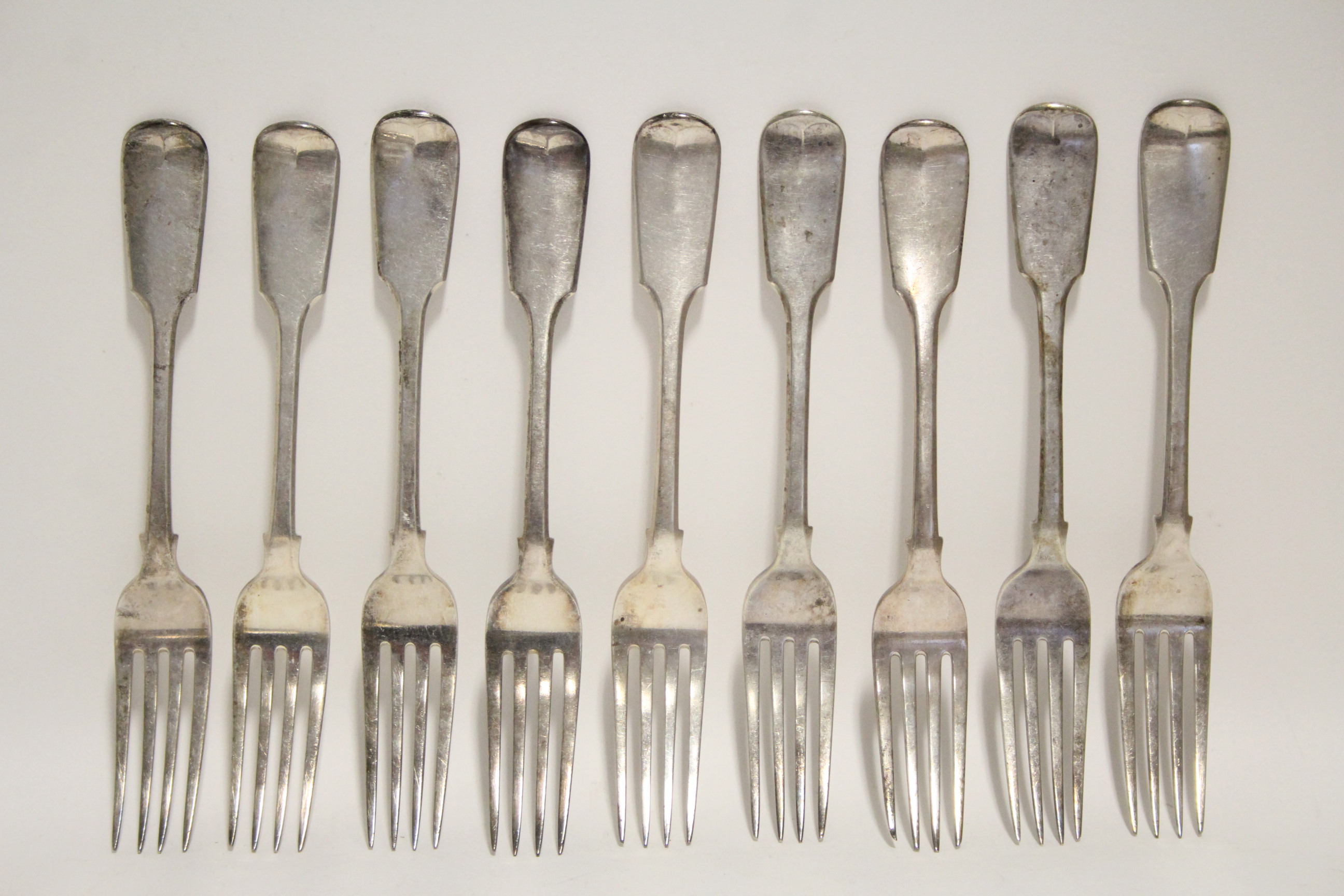 Nine William IV Fiddle pattern table forks; London 1832, by William Eaton. (20 oz).