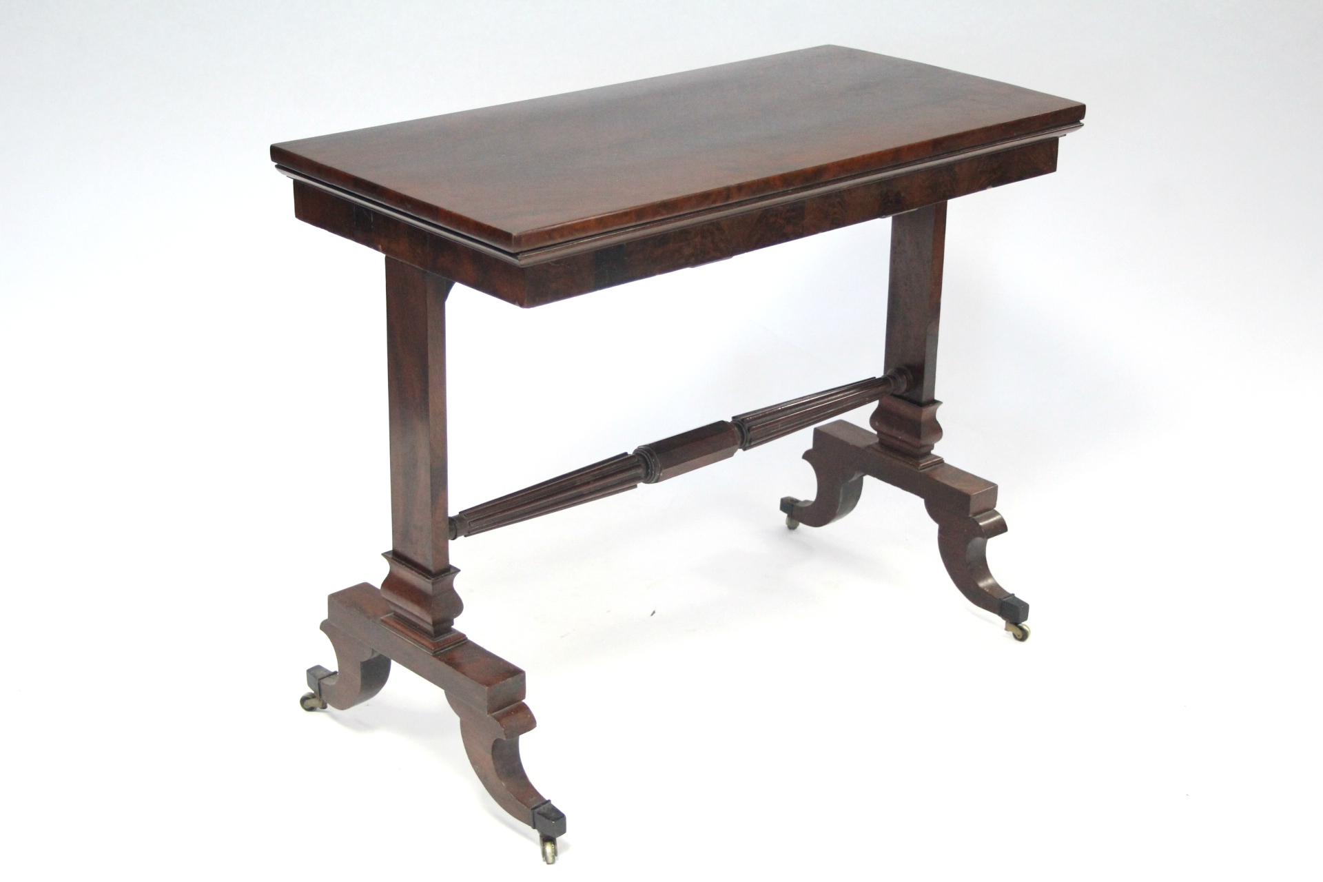 A late 19th century mahogany card table, with rectangular fold-over top on two end supports joined