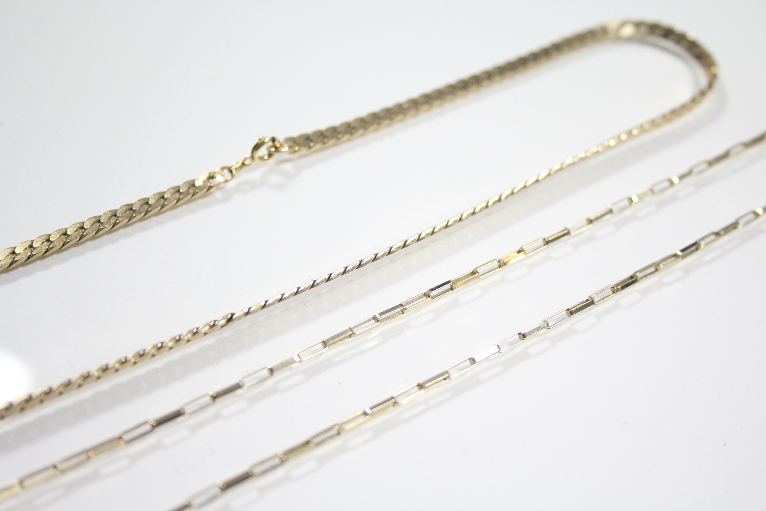 A 9ct. gold necklace of flat curb links, 16" long (14 gm); & another of small oblong links, 20" long