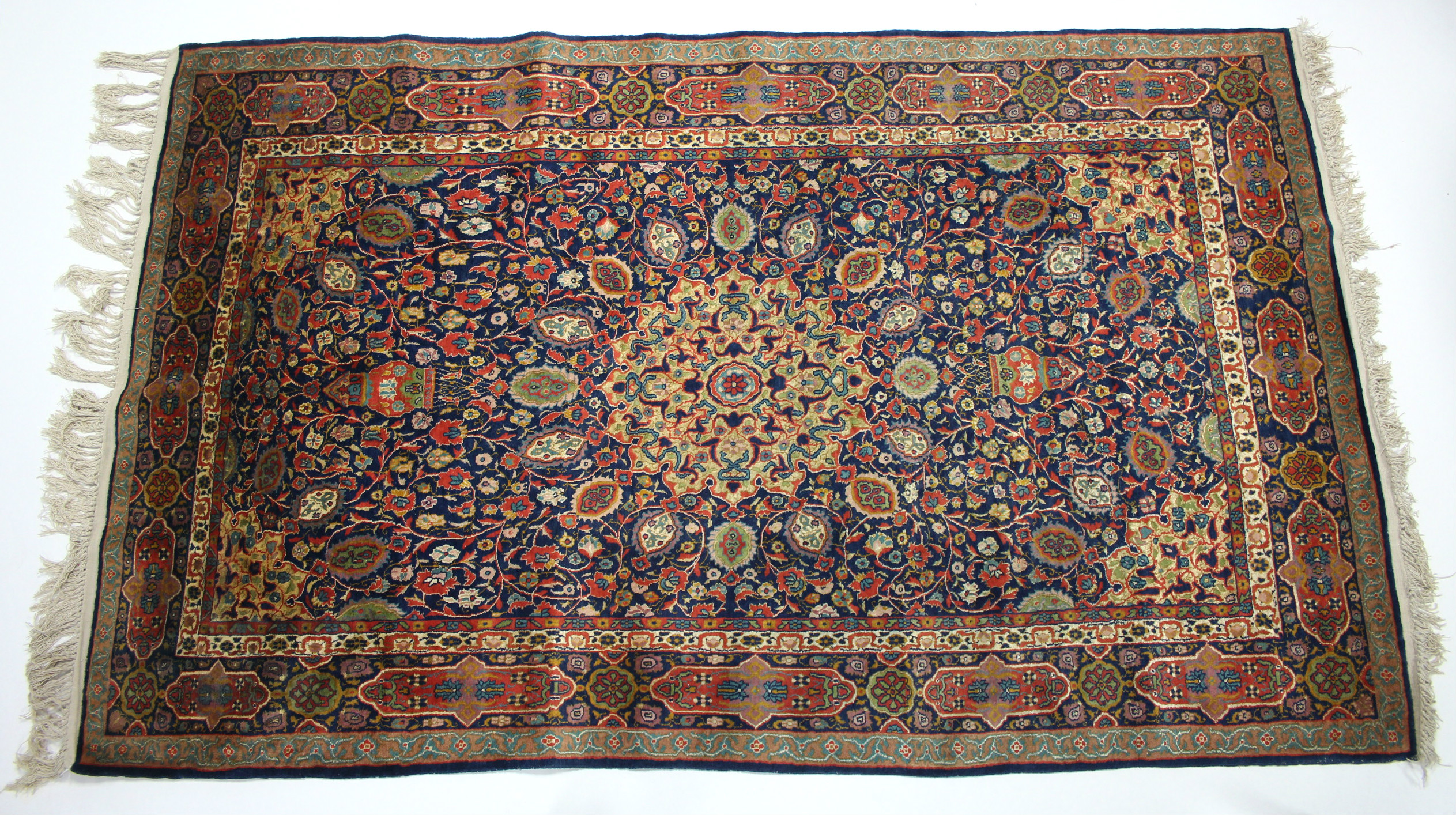 A Kashmir rug of deep blue ground, with centre medallion & all-over multicoloured floral design