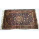 A Kashmir rug of deep blue ground, with centre medallion & all-over multicoloured floral design